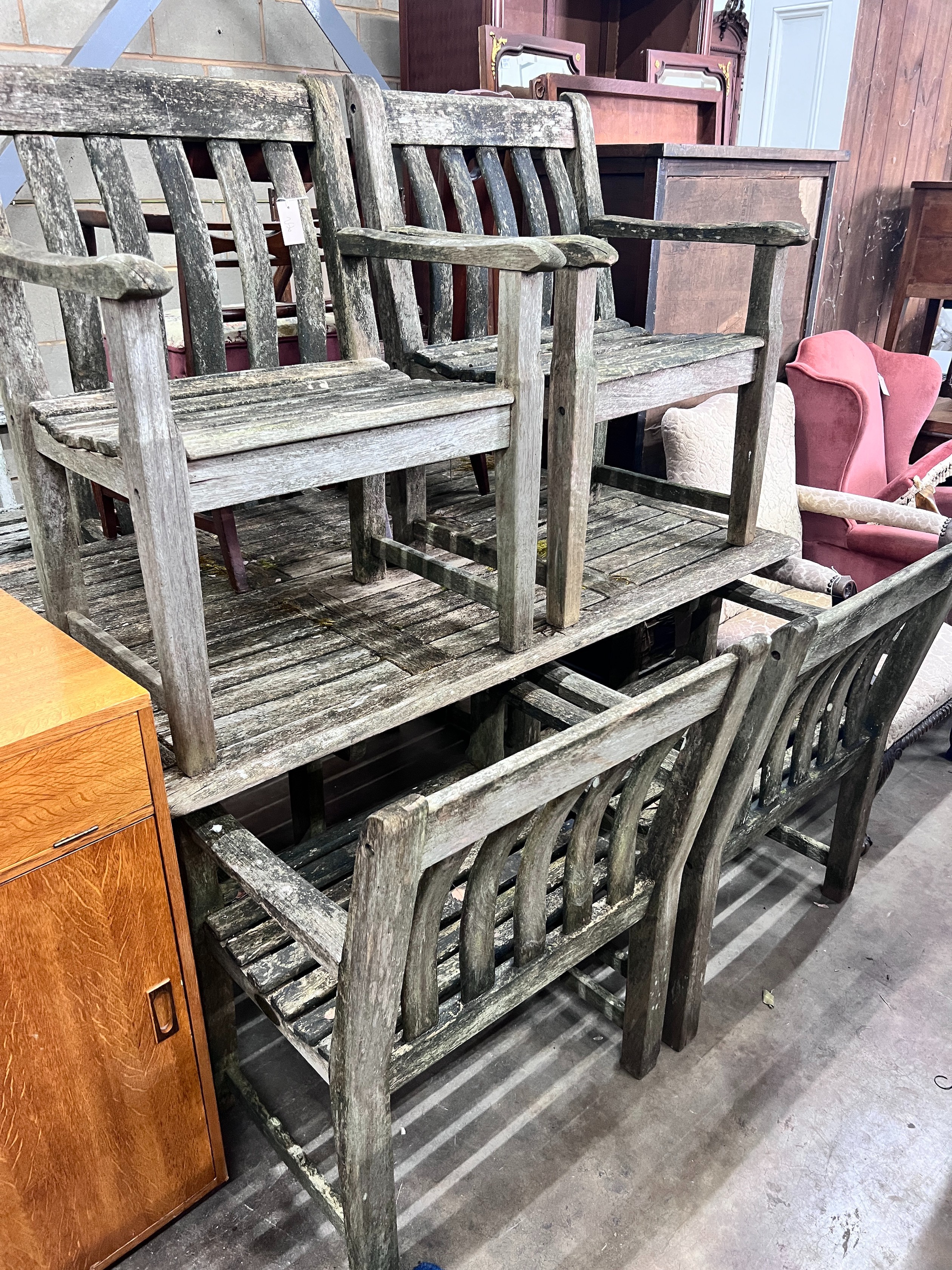 An Alexander Rose weathered teak rectangular garden table with a set of five matching armchairs, table length 161cm *Please note the sale commences at 9am.